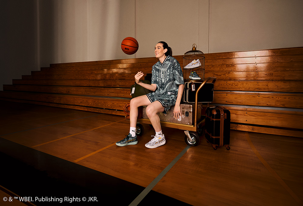 Breanna Stewart in the Puma Harry Potter range sat down and throwing a basketball