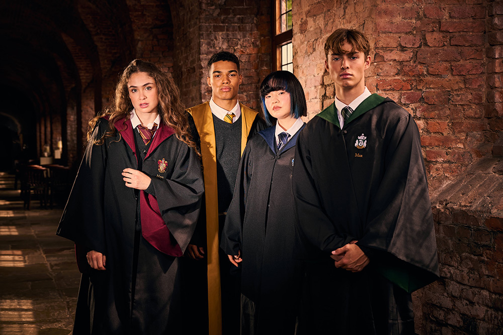 Four students wear each of the Hogwarts house robes