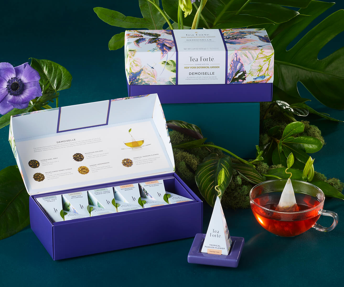 Demoiselle Petite and Presentation Box, open and closed on table with a glass cup of tea